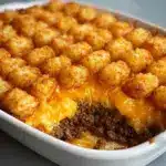 Grease a casserole dish and spread the beef mixture evenly across the bottom Recipe