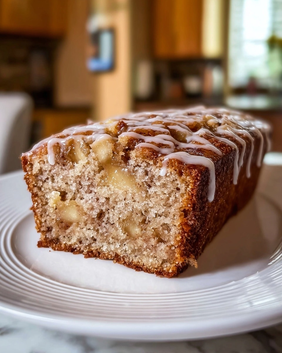 A close-up image of a moist banana nut loaf, cut to show its soft inside filled with small chunks of walnuts. The outer crust is golden brown with a slightly crispy and textured surface. A thin, white glaze drips lightly over the top, adding a thin shiny layer. The loaf sits on a white plate with a smooth finish. The background features a white marbled texture with soft natural light coming from a window. photo taken with an iphone --ar 4:5 --v 7