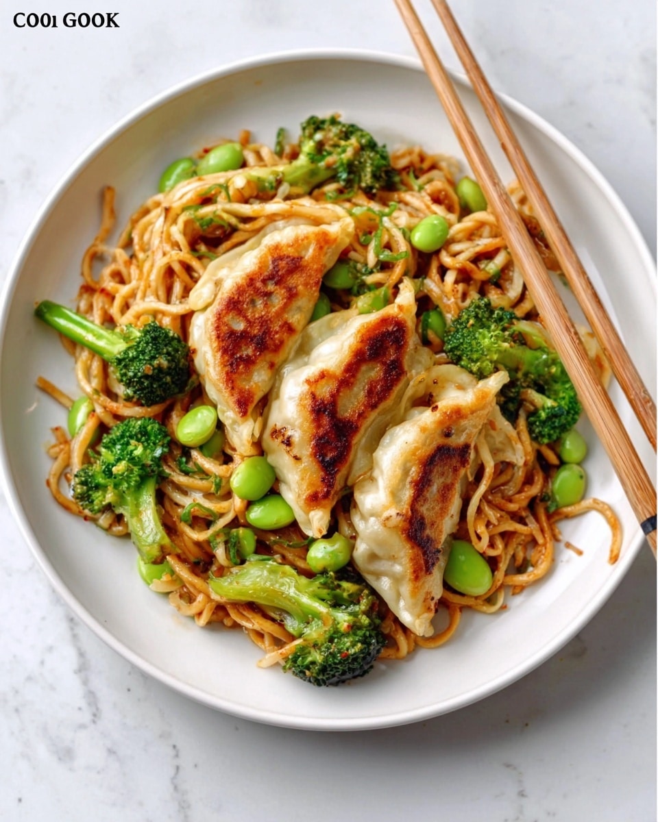 A white plate holds a serving of stir-fried noodles mixed with bright green broccoli florets and edamame beans. On top of the noodles, there are three golden-brown pan-fried dumplings arranged side by side, each with a crispy texture and slight charring. Light wooden chopsticks rest diagonally on the right side of the plate against a white marbled surface. photo taken with an iphone --ar 4:5 --v 7