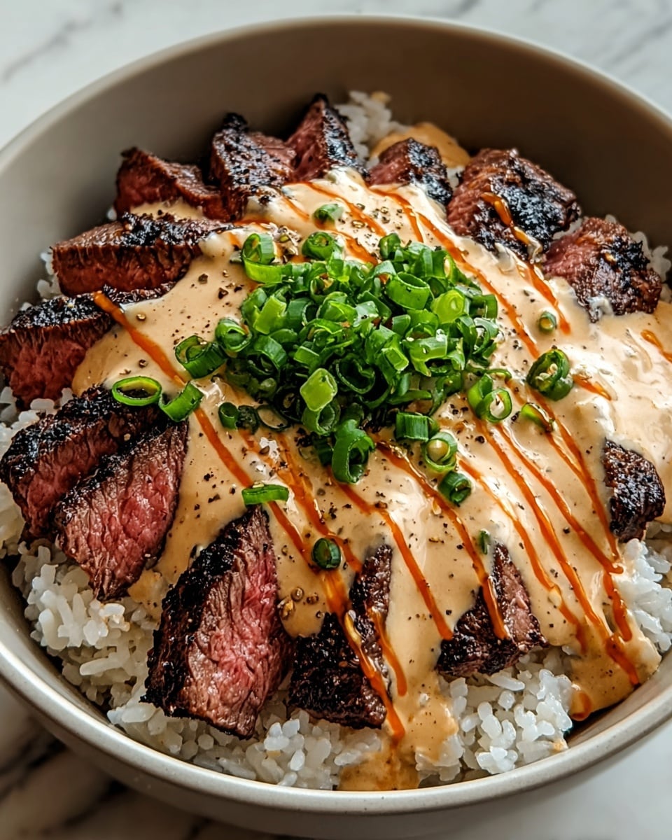 A white bowl holds a three-layer dish placed on a white marbled surface. The bottom layer is soft white rice, slightly sticky with visible grains. On top, there is a layer of grilled steak slices with dark char marks and a pink center, arranged in a circular pattern. The steak is generously covered with a creamy, pale orange sauce that looks smooth and slightly thick. Bright green chopped scallions are sprinkled on the sauce, along with thin drizzles of a darker orange spicy sauce adding contrast. The overall look is colorful and fresh, with clear textures in each layer. Photo taken with an iphone --ar 4:5 --v 7