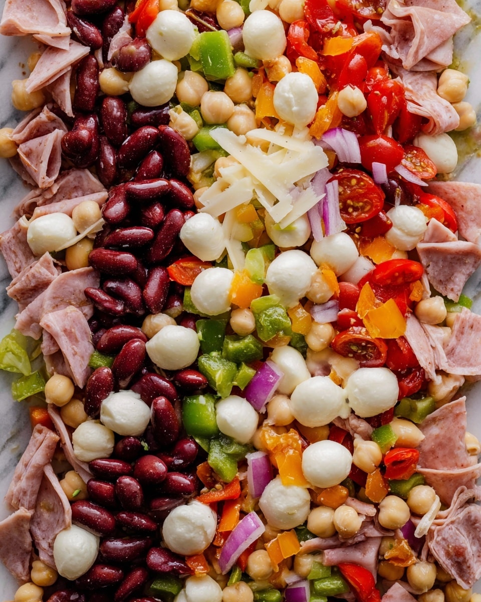 This image shows a close-up of a colorful salad with many ingredients mixed together. The salad has five main layers: kidney beans that are dark red and shiny, chickpeas that are beige and round, small mozzarella balls that are white and smooth, thin slices of light pink turkey or ham, and small pieces of red and green bell peppers. There are also bits of cherry tomatoes that are bright red and juicy, thin slices of red onion that are light purple and translucent, and small pieces of orange and yellow bell peppers adding extra color. The salad looks fresh with a slight shine from a light dressing, all placed on a white marbled surface. photo taken with an iphone --ar 4:5 --v 7