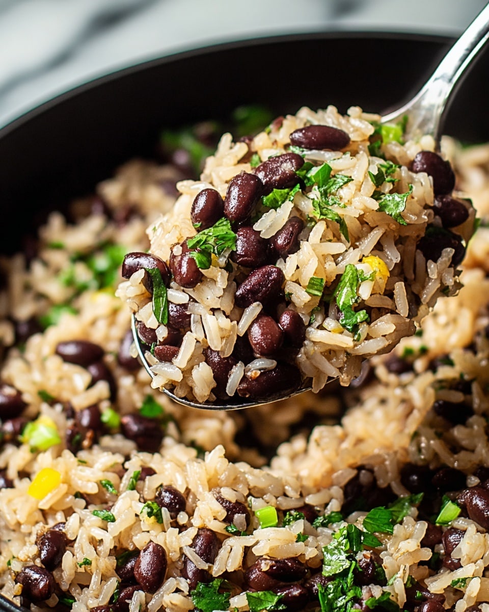 The image shows a close-up of a spoon lifting a scoop of cooked rice mixed with black beans, small chopped green herbs, and tiny bits of yellow peppers. The cooked rice is light brown in color, and the black beans are evenly spread throughout the mixture. The texture of the rice looks soft and fluffy, while the black beans appear firm. The herbs add fresh green color, scattered on top and throughout the dish. The spoon is silver and full of the rice and bean mixture. The dish is in a black pan, with a white marbled surface in the background. photo taken with an iphone --ar 4:5 --v 7