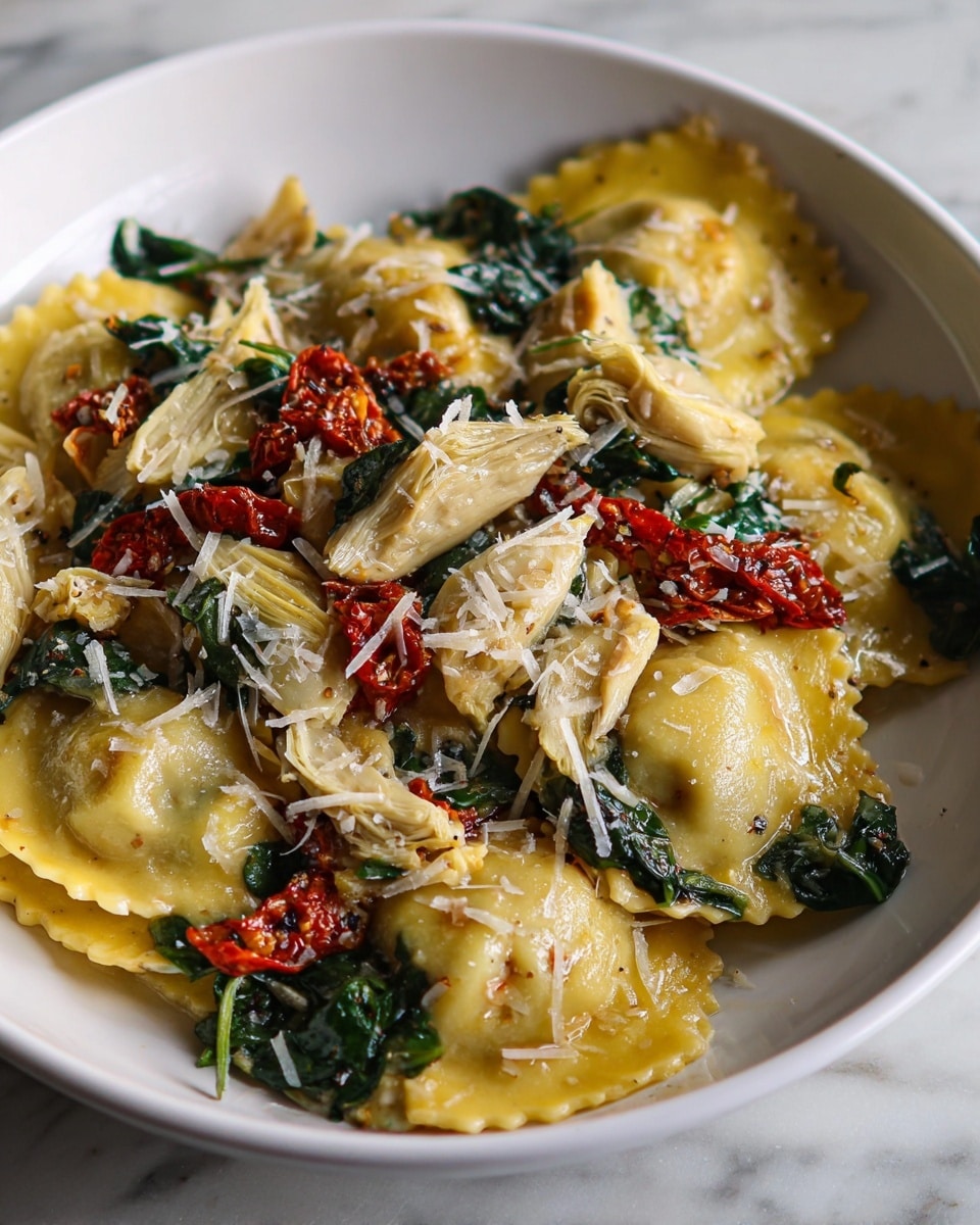 A white bowl filled with three large yellow ravioli pieces as the first layer, each ravioli having a delicate, slightly ruffled edge and a soft texture. Scattered over the ravioli are rough pieces of pale beige artichoke hearts and dark green cooked spinach leaves as the second layer. On top of these layers, small bright red sun-dried tomato pieces and finely shredded white cheese are sprinkled evenly, enhancing the dish with color contrast and texture. The whole dish sits on a white marbled surface. photo taken with an iphone --ar 4:5 --v 7